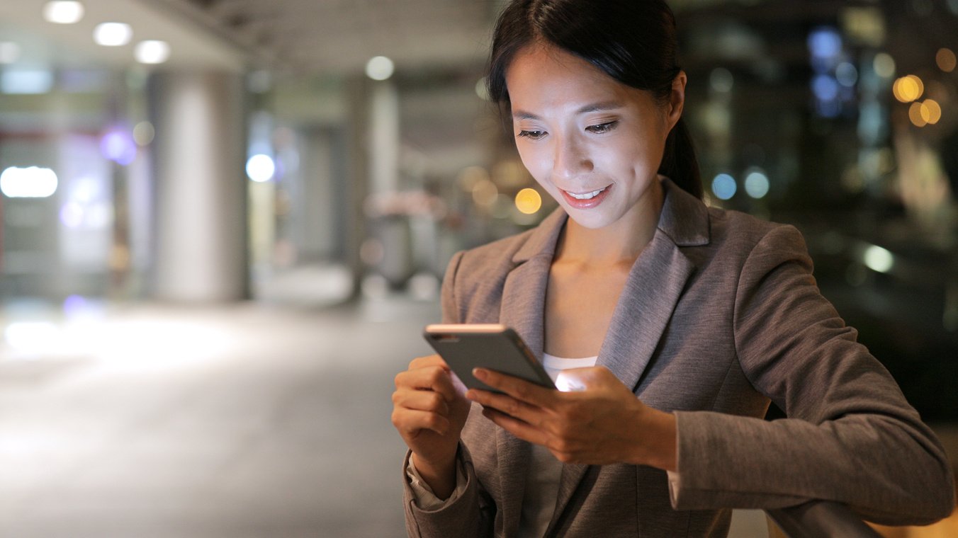 Businesswoman Sending Sms on Cellphone